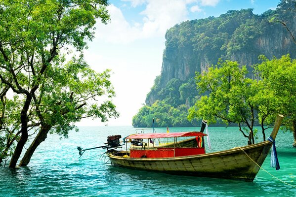 Fishing boats on the beach of the sea. On the shore of the tropics boat