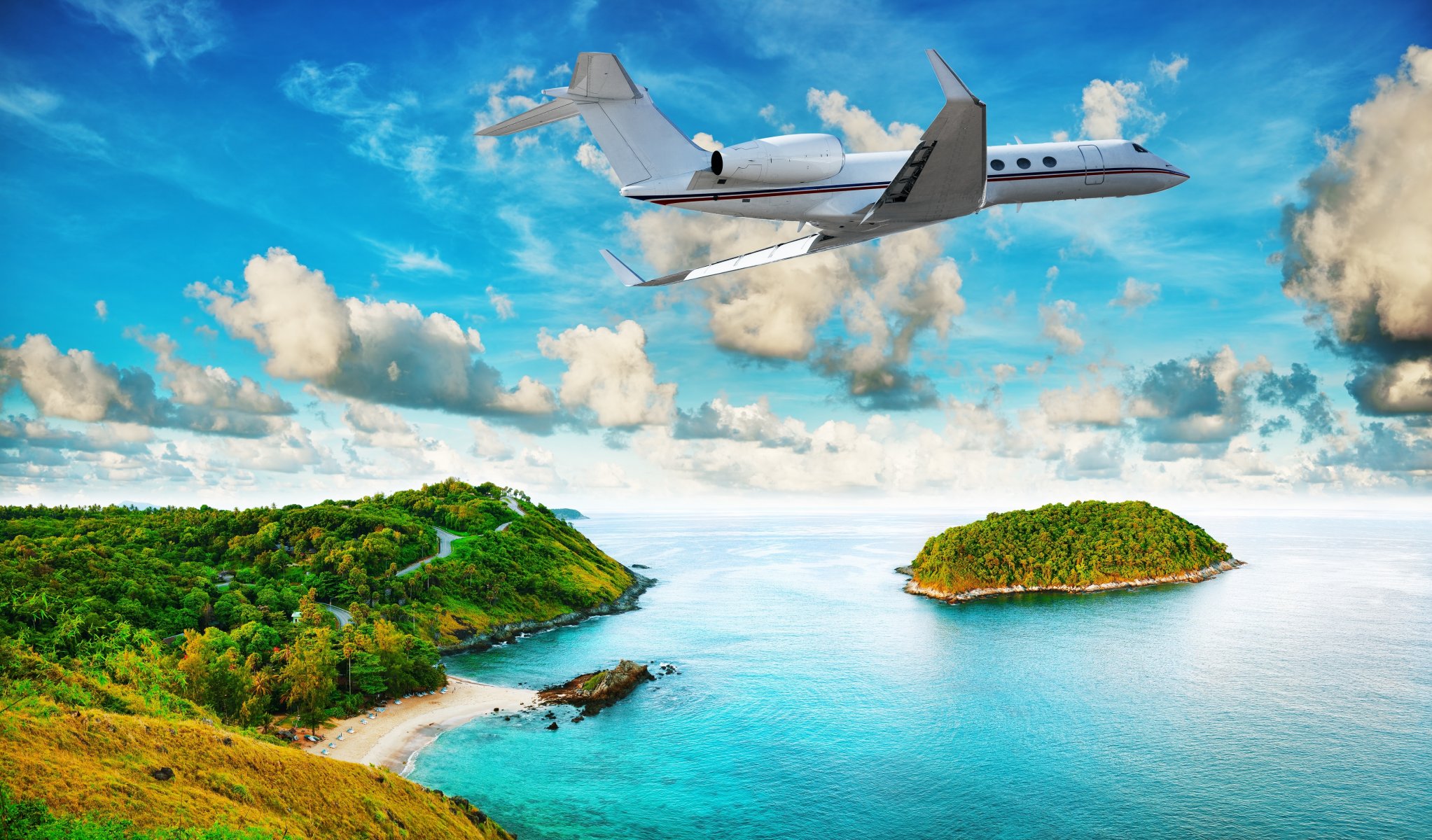 avión volando sobre la isla trópicos playa mar