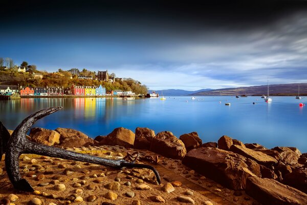 Rusty anchor on the background of a picturesque bay