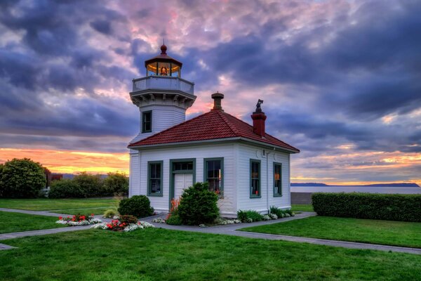 A house with a lighthouse in a picturesque area