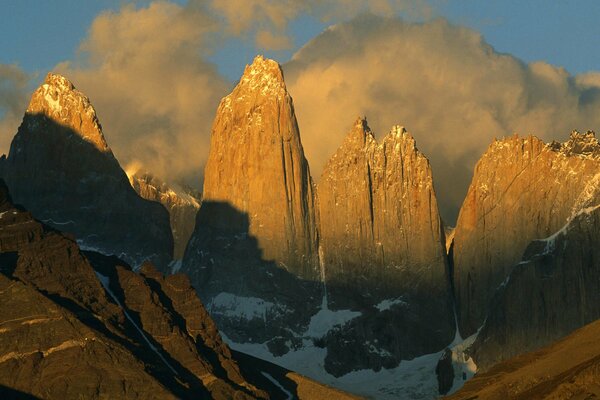 The peaks of the mountains rise into the sky