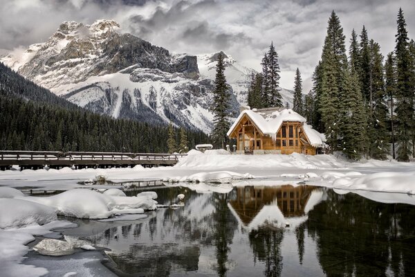 Winter nature . a hut on the shore of the lake