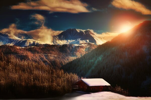 Promienie słońca oświetlają zaśnieżony dom w górach