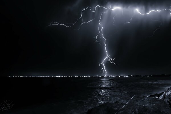 Lightning in the night sky, near the sea