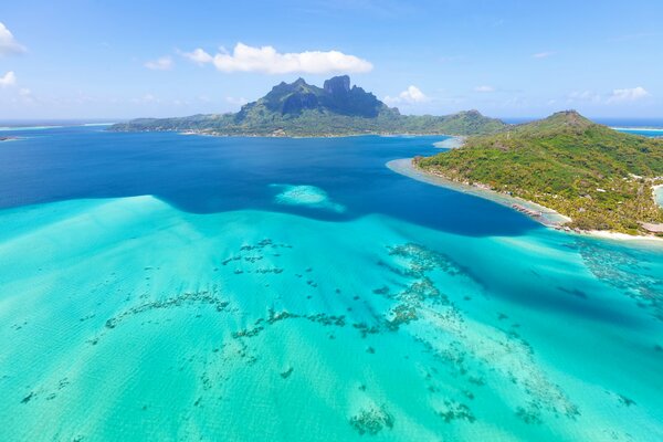 Tropical islands in the ocean against the background of mountains