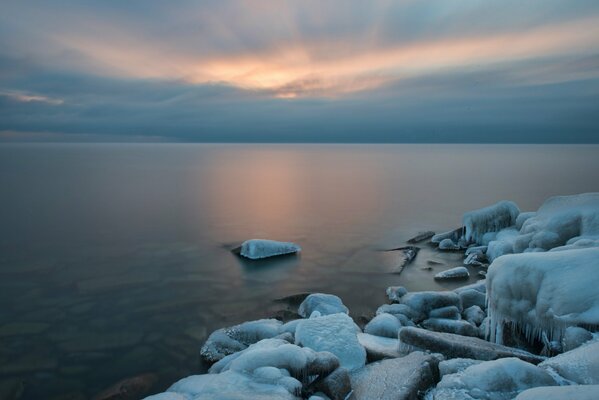 Winter pond. Sunset. Ice Coast