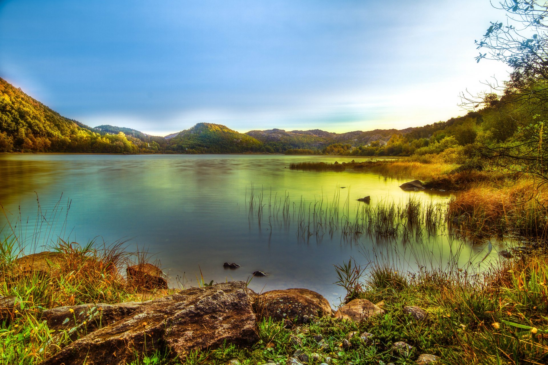 mountain. lake beach stones grass sky