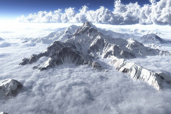 Snow-capped mountain tops in the clouds