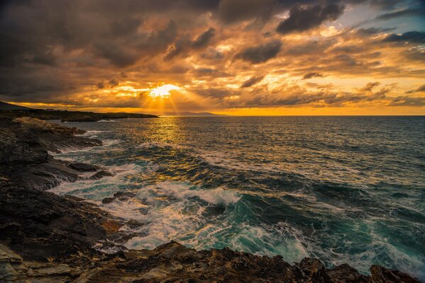 Captive waves beat against the rocks