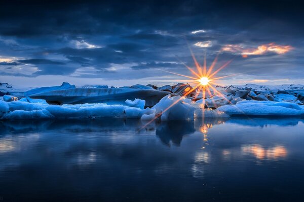 Glaciers on the lake on the background of sunset