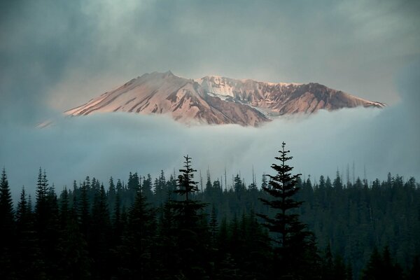 A snowy peak in thick clouds