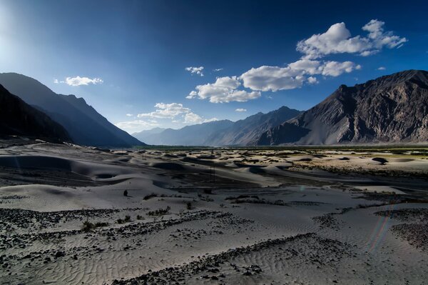 Mountains and sand under a blue sky