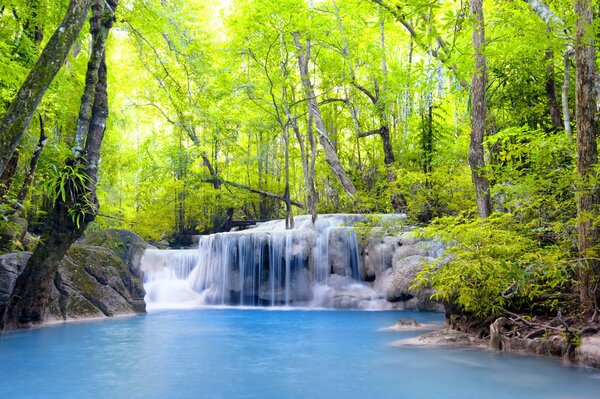 Blue lake yellow leaves on trees and waterfall