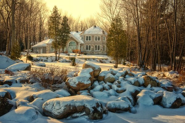 Winter house in snow rocks