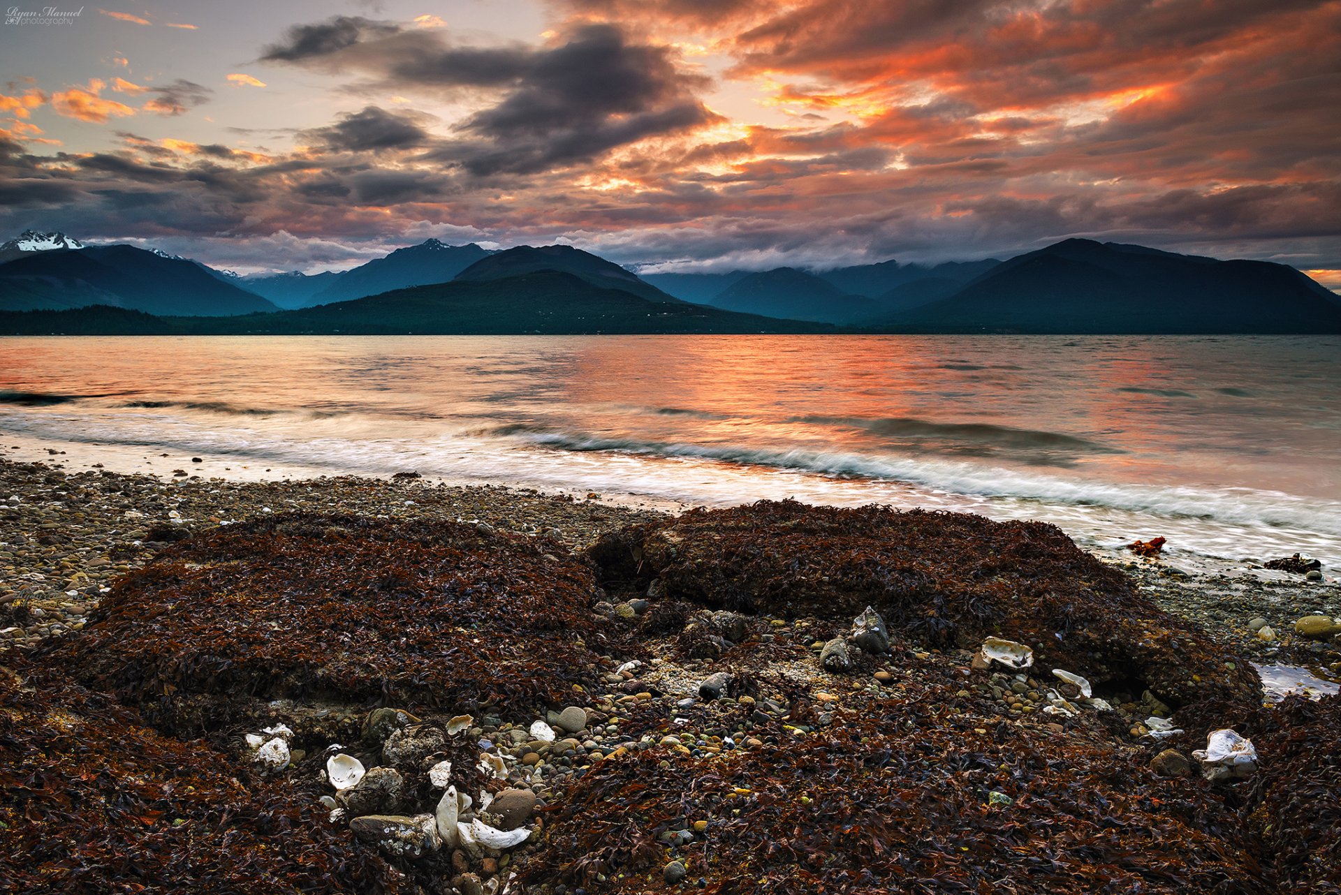 mountain beach pebbles algae sea sunset