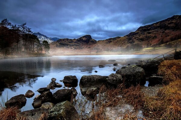 Atmospheric photo of an autumn lake in fog