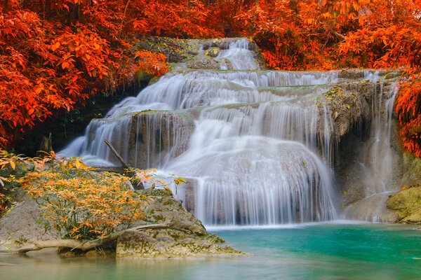 Autumn waterfall in the mountains with green water