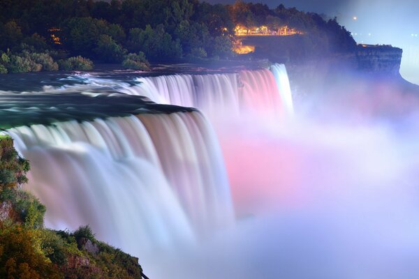 A waterfall illuminated by lights in the park