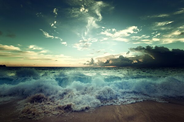 Surf on the shore with sand and waves