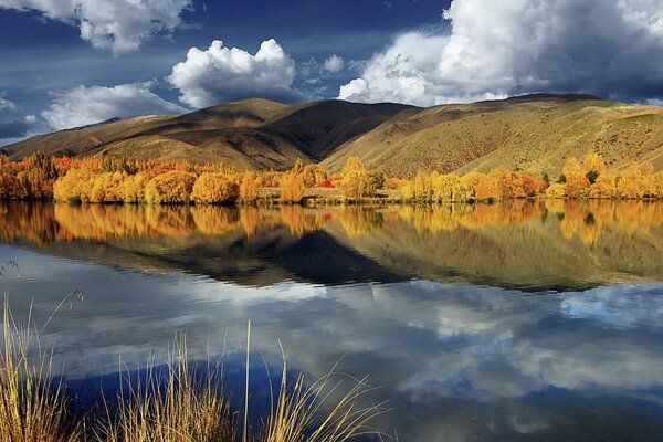 Autumn nature with hills and a pond