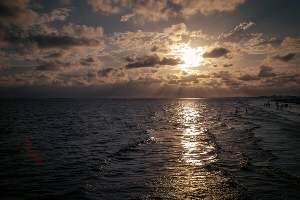 The undulating sea of a relaxing beach in the evening sunlight