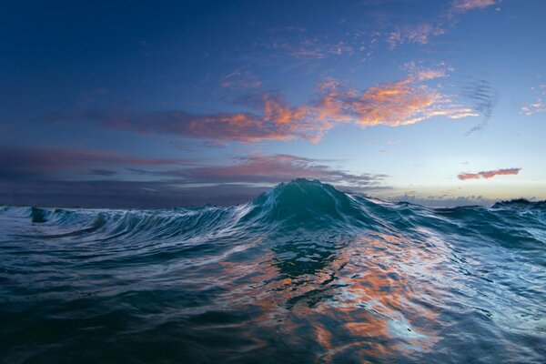 Sunset in the ocean with a beautiful wave