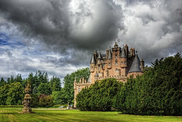 Scottish castle with lawn and forest