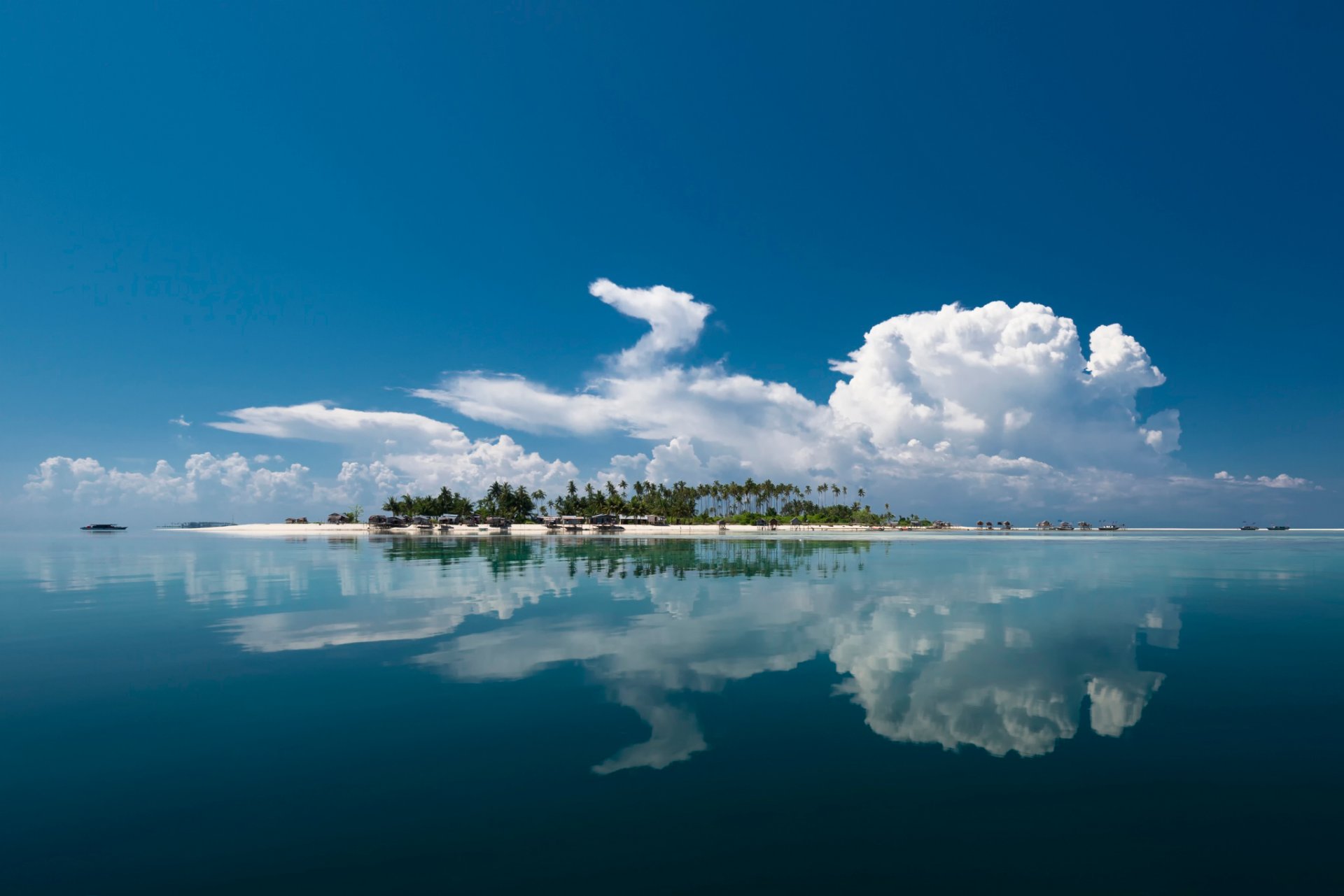 island sea clouds reflection