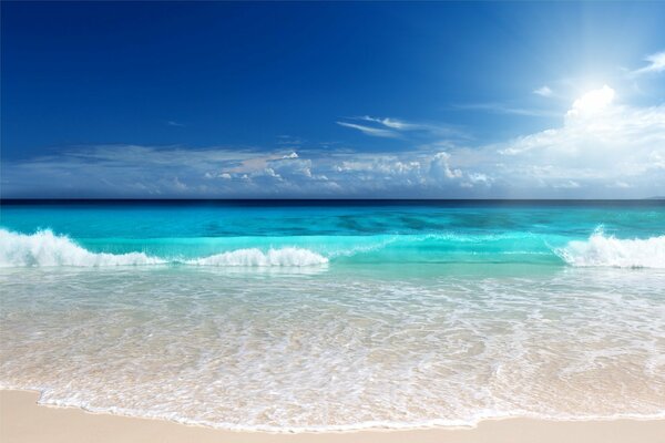 Bright blue-emerald sea and sandy beach