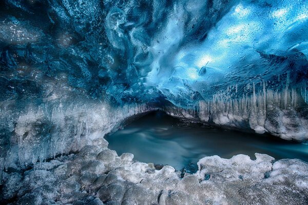 A glacier in the snow looks like a tunnel to another world