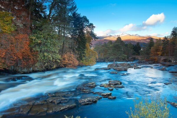 A river among hills and autumn forest