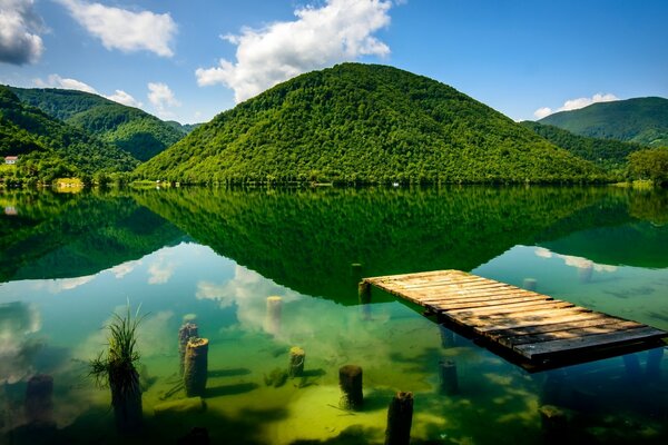 Reflection of green hills in the lake