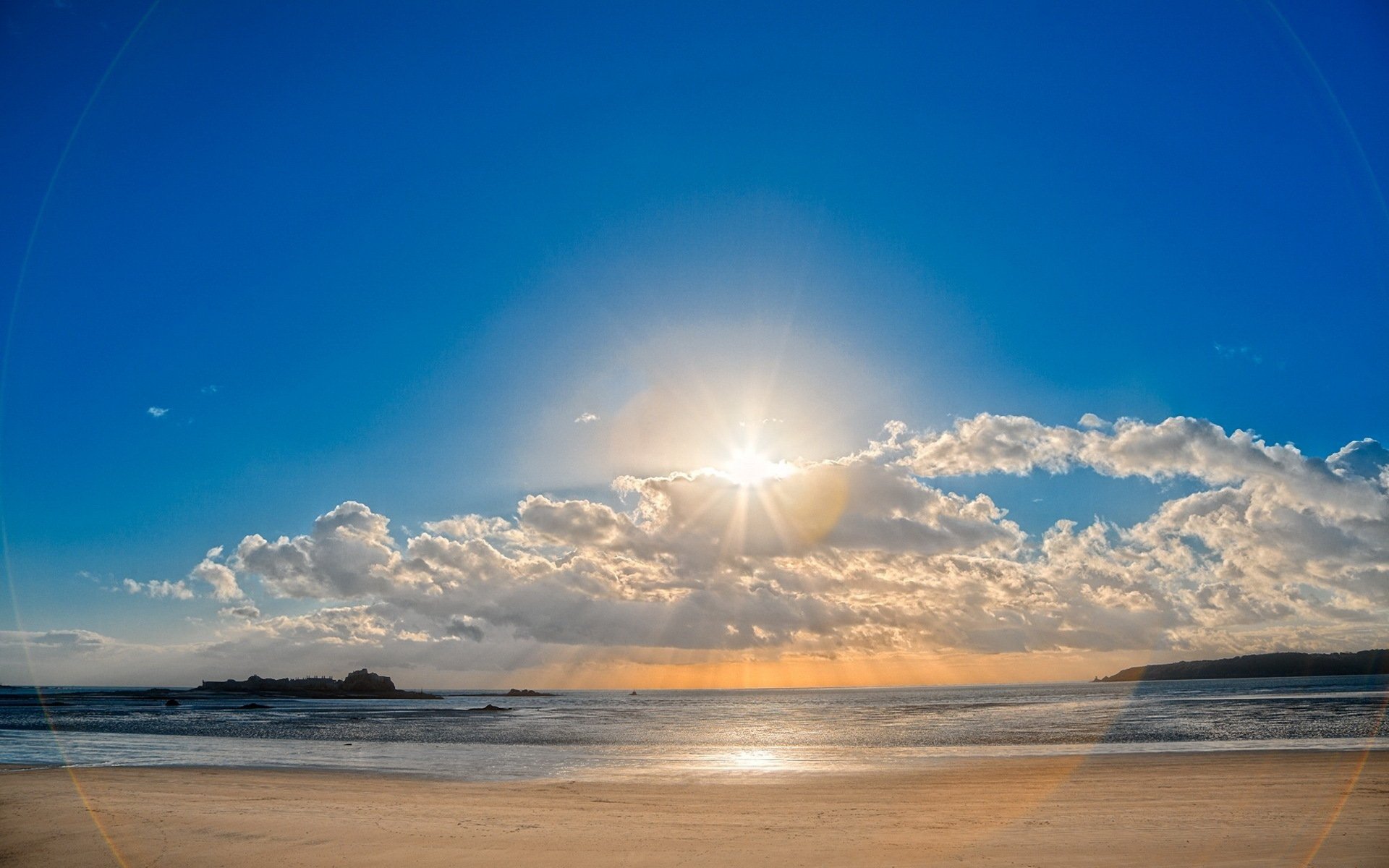 beach sand sky clouds sun reflection