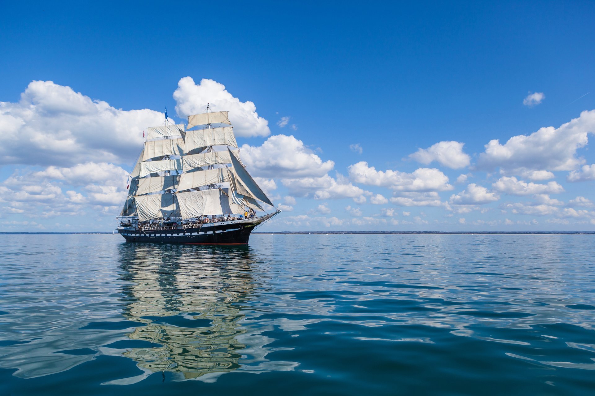 ea ship sail clouds reflection