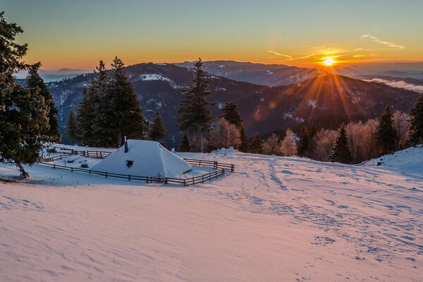 Snowy morning in the mountains. a house in the mountains