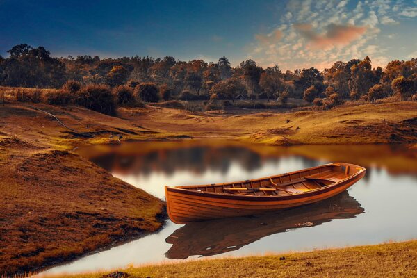 An abandoned boat stranded on a lake