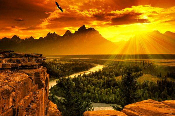 Beautiful sunset on the background of mountains, forests and rocks