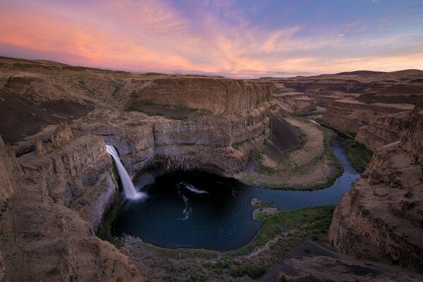 Waterfall in the canyon at sunrise