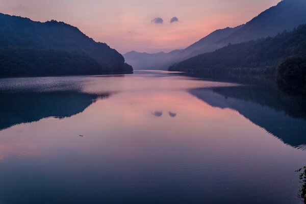 Lago y montañas puesta de sol rosa