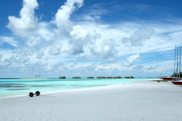 Airy white clouds hovering over the turquoise ocean