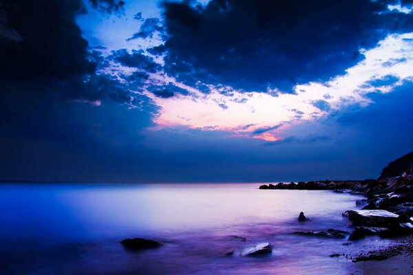 Night ocean coast with purple water