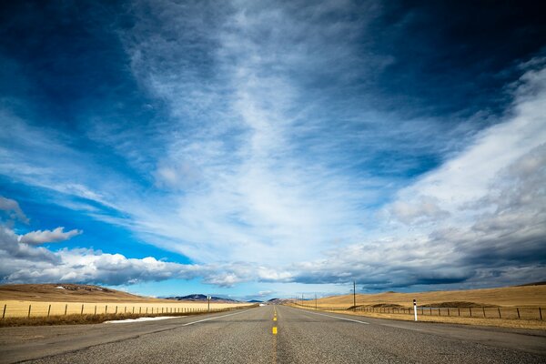 A long road in Canada on a clear day