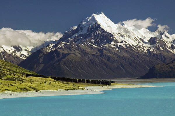 White clouds, holy mountain, green trees 