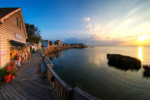 Picturesque beach with houses at sunset