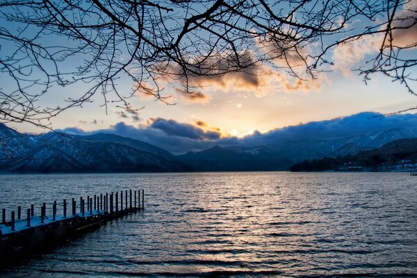 Lake on the background of a mountain and sunset