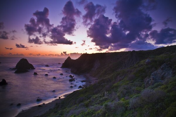 Sunset on the rocky ocean beach