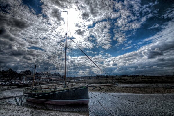 The unique sky stretches over the boat in the sea