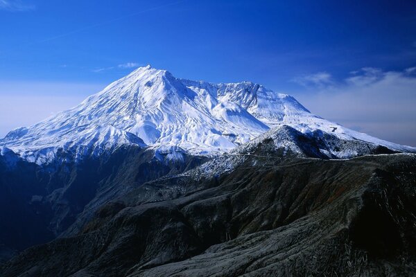 A snow-white mountain against a blue sky