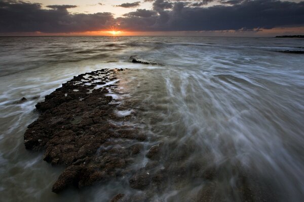 Clouds at sunrise on the background of the sea