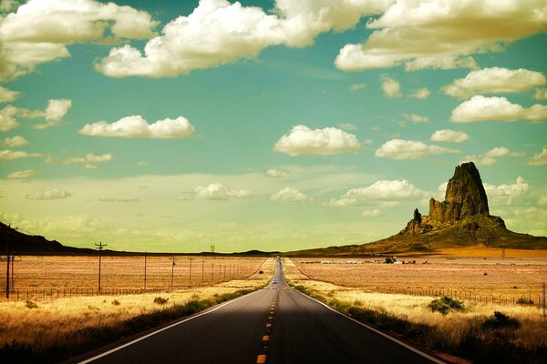 The road stretches like a ribbon through the desert and mountains